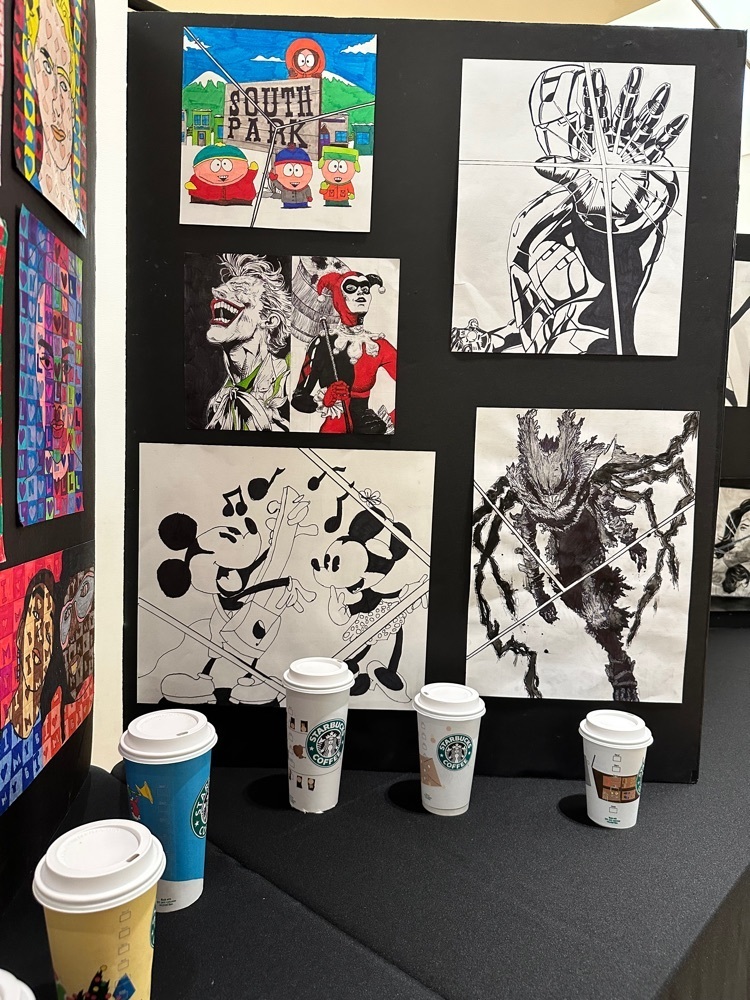 black and white art displayed on a board. receding for Starbucks cups 